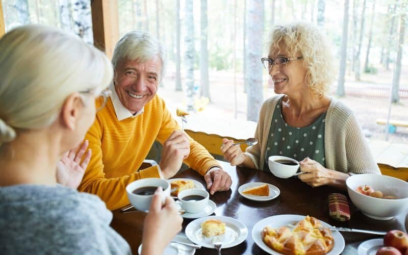 Seniors enjoing a meal at a table